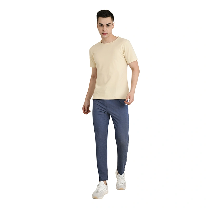 Male model in cream round-neck t-shirt with navy blue trousers and white sneakers - menswear ecommerce photography by Lohar Studio Delhi